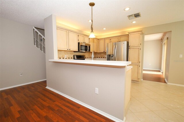 2205 Wyndam Way, Kissimmee, FL 34743 - kitchen featuring stainless steel appliances, light countertops, recessed lighting, tasteful backsplash, and a peninsula