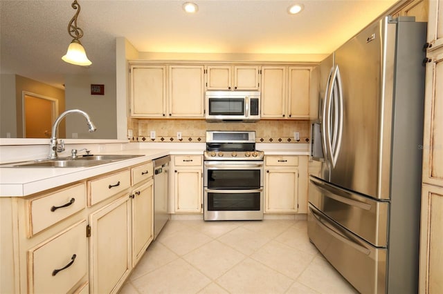 2205 Wyndam Way, Kissimmee, FL 34743 - kitchen with appliances with stainless steel finishes, a peninsula, light countertops, tasteful backsplash, and recessed lighting