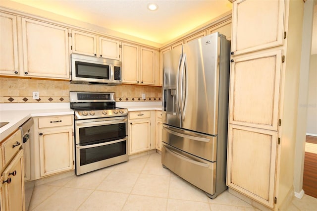2205 Wyndam Way, Kissimmee, FL 34743 - kitchen featuring stainless steel appliances, cream cabinetry, light countertops, and recessed lighting