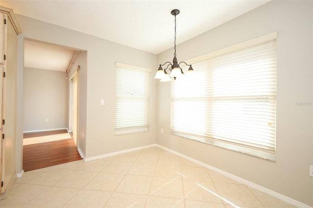 2205 Wyndam Way, Kissimmee, FL 34743 - unfurnished dining area featuring a chandelier and baseboards