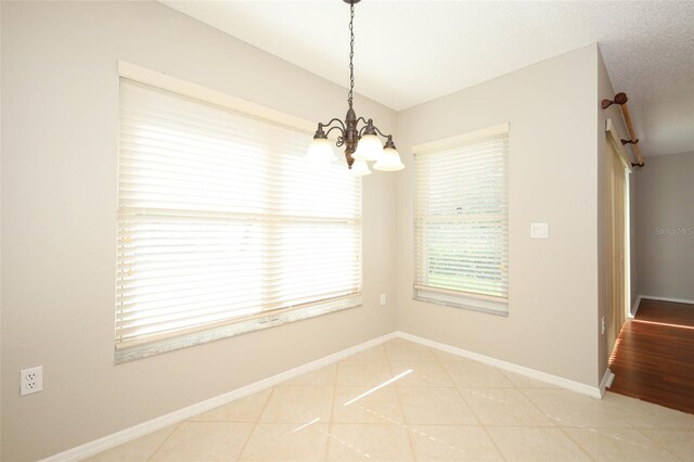2205 Wyndam Way, Kissimmee, FL 34743 - unfurnished dining area featuring a chandelier and light tile patterned floors