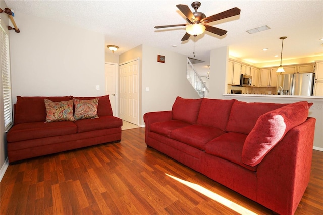 2205 Wyndam Way, Kissimmee, FL 34743 - living area featuring wood finished floors, a ceiling fan, and stairs
