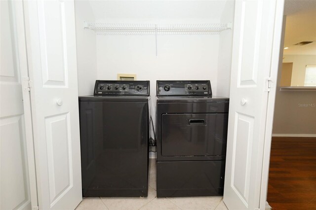 2205 Wyndam Way, Kissimmee, FL 34743 - laundry area featuring washer and clothes dryer and light wood-style flooring