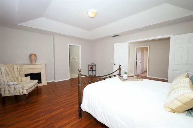 2205 Wyndam Way, Kissimmee, FL 34743 - bedroom featuring a raised ceiling, wood finished floors, and a high end fireplace