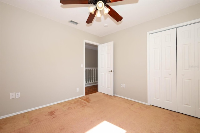 2205 Wyndam Way, Kissimmee, FL 34743 - unfurnished bedroom featuring light colored carpet, a closet, and a ceiling fan