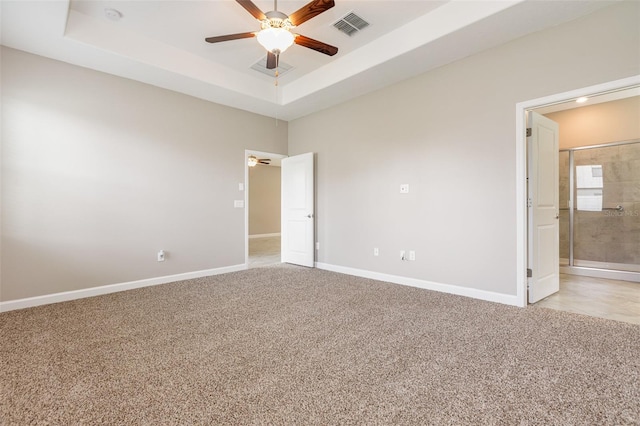 13209 Haystack Ct, Riverview, FL 33579 - unfurnished bedroom featuring light carpet, a raised ceiling, a ceiling fan, and connected bathroom