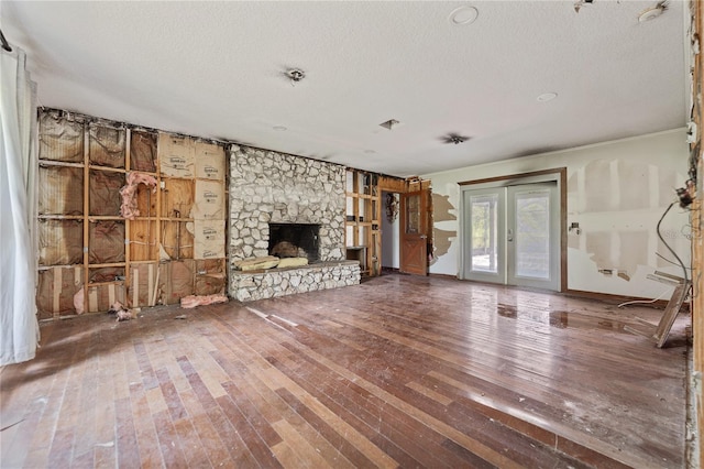 8735 Rancho Ct, Orlando, FL 32836 - unfurnished living room featuring wood-type flooring, a textured ceiling, and a fireplace