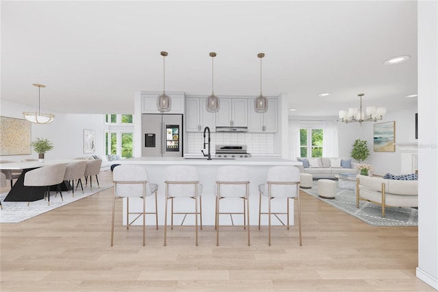 8735 Rancho Ct, Orlando, FL 32836 - kitchen with stainless steel refrigerator with ice dispenser, open floor plan, range, light countertops, and recessed lighting