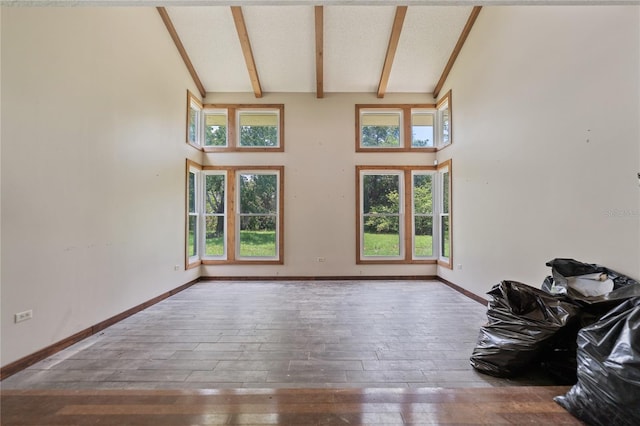 8735 Rancho Ct, Orlando, FL 32836 - unfurnished living room with hardwood / wood-style floors, beam ceiling, high vaulted ceiling, and baseboards