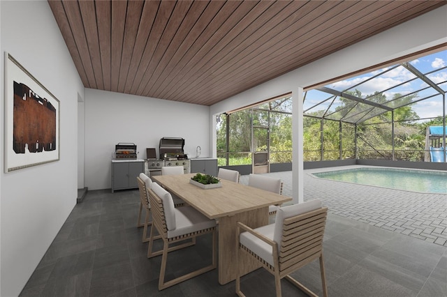 8735 Rancho Ct, Orlando, FL 32836 - sunroom / solarium with exterior kitchen, outdoor dining area, and a swimming pool