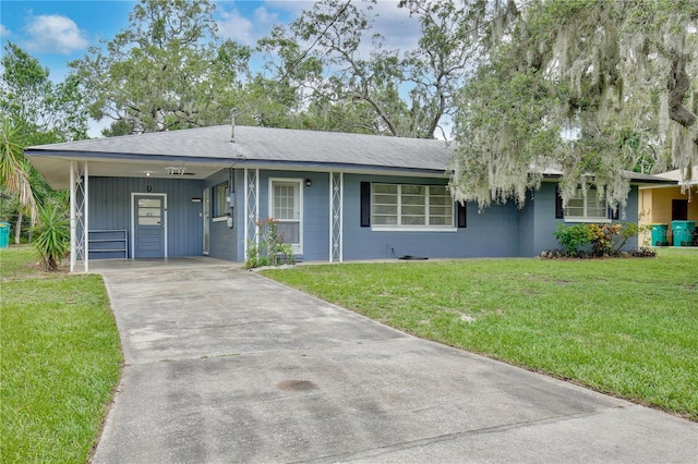 1607 Lindale Ave, Eustis, FL 32726 - single story home with a front yard, concrete driveway, a carport, and a shingled roof