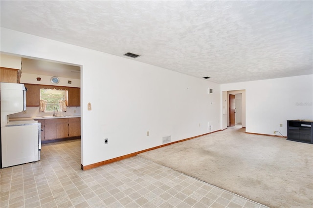 1607 Lindale Ave, Eustis, FL 32726 - unfurnished living room with a sink and a textured ceiling