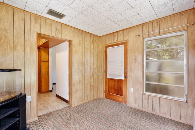 1607 Lindale Ave, Eustis, FL 32726 - carpeted empty room with wooden walls and baseboards