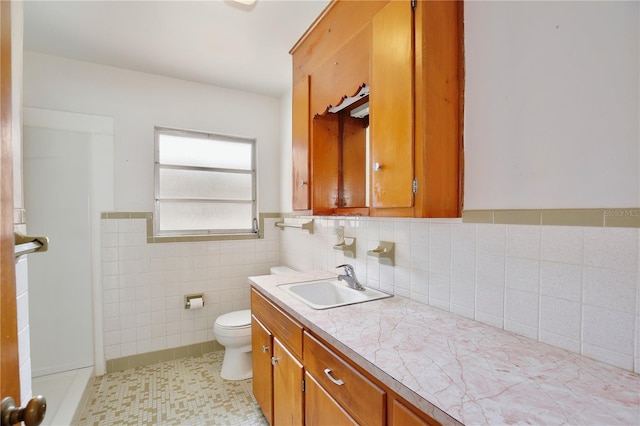 1607 Lindale Ave, Eustis, FL 32726 - bathroom featuring vanity, a wainscoted wall, tile walls, and tile patterned floors