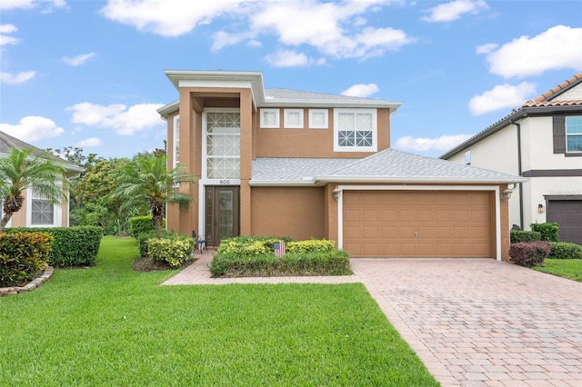 600 Egret Place Dr, Winter Garden, FL 34787 - view of front of property featuring stucco siding, a front lawn, and driveway