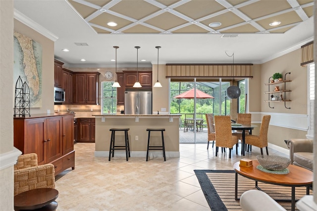 600 Egret Place Dr, Winter Garden, FL 34787 - kitchen with stainless steel appliances, coffered ceiling, a kitchen bar, plenty of natural light, and a center island