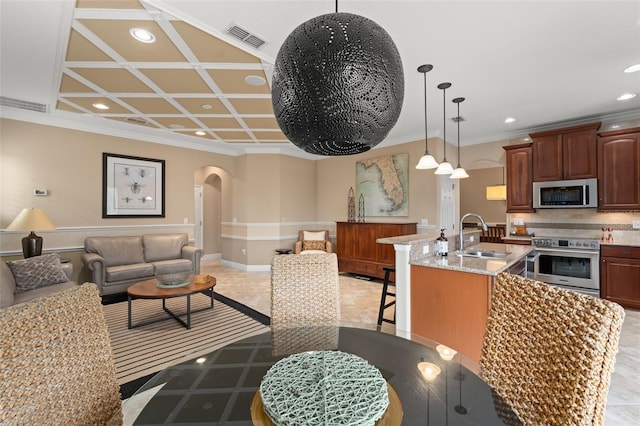 600 Egret Place Dr, Winter Garden, FL 34787 - kitchen featuring appliances with stainless steel finishes, a sink, arched walkways, a breakfast bar area, and recessed lighting