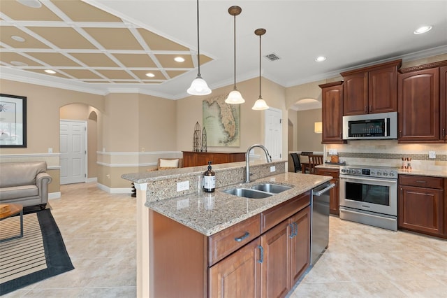 600 Egret Place Dr, Winter Garden, FL 34787 - kitchen with arched walkways, stainless steel appliances, a sink, tasteful backsplash, and recessed lighting