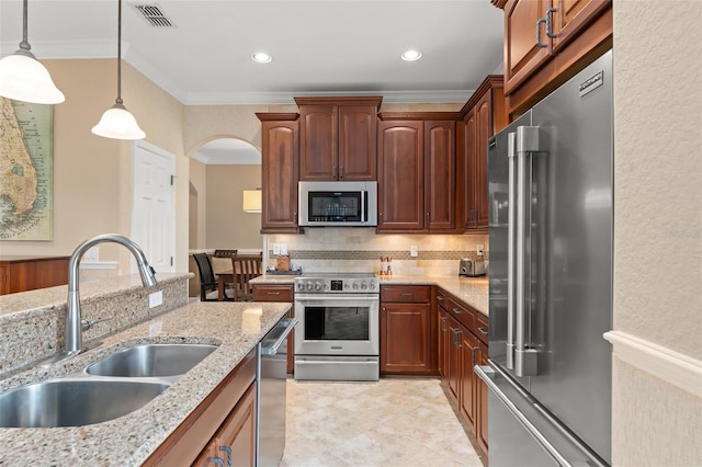 600 Egret Place Dr, Winter Garden, FL 34787 - kitchen featuring stainless steel appliances, a sink, crown molding, backsplash, and hanging light fixtures