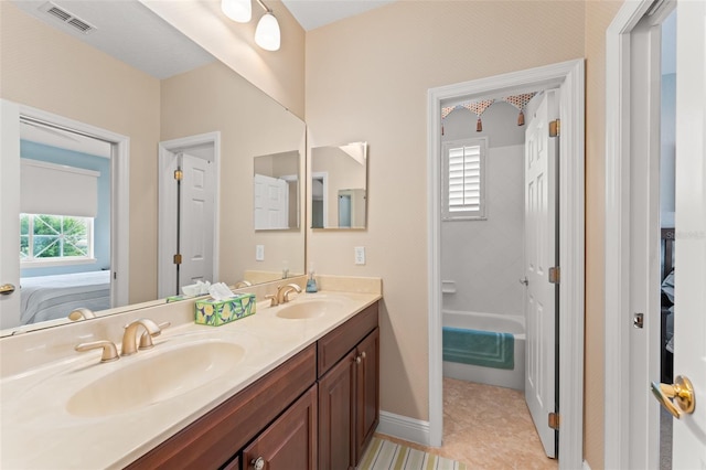 600 Egret Place Dr, Winter Garden, FL 34787 - ensuite bathroom with double vanity, healthy amount of natural light, baseboards, and tile patterned flooring
