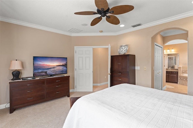 600 Egret Place Dr, Winter Garden, FL 34787 - bedroom featuring arched walkways, ornamental molding, baseboards, ensuite bathroom, and a sink