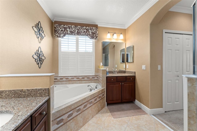 600 Egret Place Dr, Winter Garden, FL 34787 - full bathroom featuring two vanities, ornamental molding, a bath, and tile patterned floors