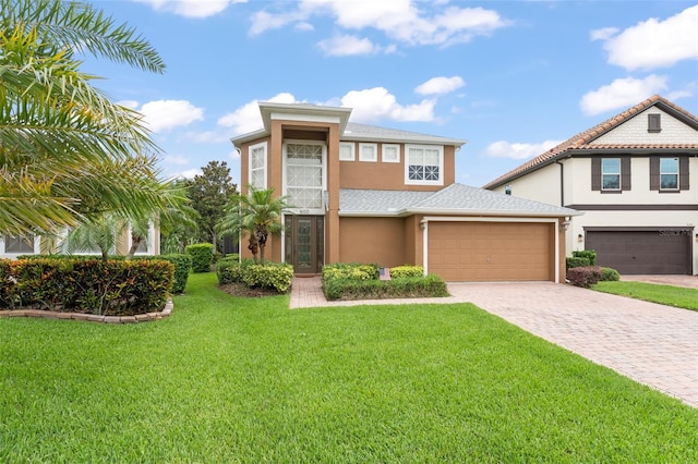 600 Egret Place Dr, Winter Garden, FL 34787 - view of front of property featuring stucco siding, driveway, a front yard, and an attached garage