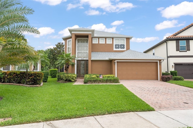 600 Egret Place Dr, Winter Garden, FL 34787 - view of front of property with stucco siding, driveway, a front lawn, and an attached garage