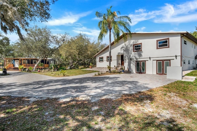 40140 Swift Rd, Eustis, FL 32736 - view of front facade with stucco siding, french doors, and a wooden deck