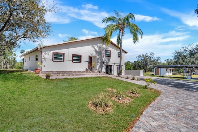 40140 Swift Rd, Eustis, FL 32736 - view of front facade featuring a front lawn, stucco siding, and decorative driveway