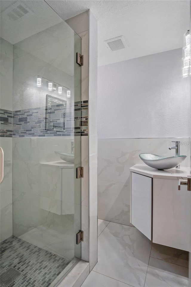 40140 Swift Rd, Eustis, FL 32736 - full bathroom featuring vanity, a shower stall, and marble finish floors