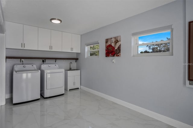 40140 Swift Rd, Eustis, FL 32736 - laundry area with washing machine and clothes dryer, cabinet space, light marble finish floors, and baseboards
