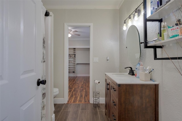 40140 Swift Rd, Eustis, FL 32736 - bathroom with vanity, wood finished floors, crown molding, toilet, and baseboards