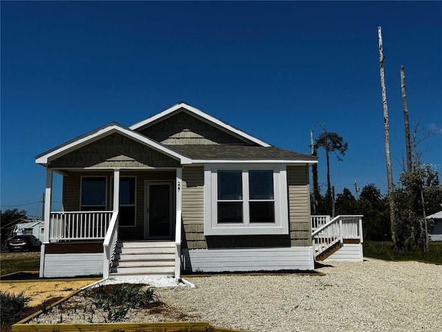 227 Bay St, Port St Joe, FL 32456 - view of front of house with a porch, stairs, and roof with shingles