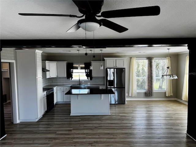 227 Bay St, Port St Joe, FL 32456 - kitchen with refrigerator with ice dispenser, a ceiling fan, a center island, white cabinetry, and dark wood-style flooring