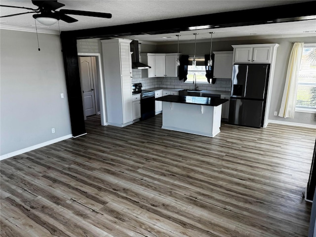 227 Bay St, Port St Joe, FL 32456 - kitchen featuring black appliances, a ceiling fan, a sink, dark countertops, and backsplash