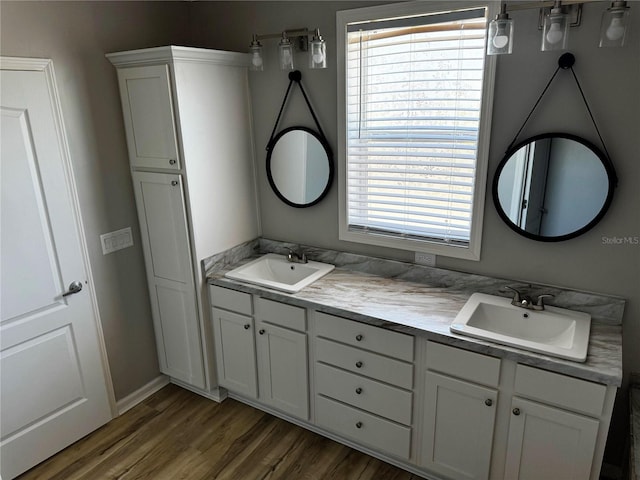 227 Bay St, Port St Joe, FL 32456 - bathroom with double vanity, wood finished floors, and baseboards