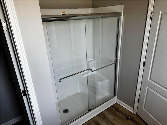 227 Bay St, Port St Joe, FL 32456 - full bath featuring wood finished floors, a stall shower, and baseboards