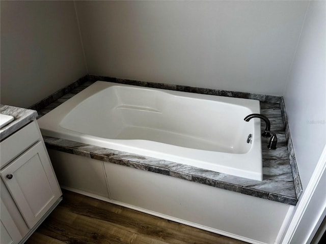 227 Bay St, Port St Joe, FL 32456 - full bathroom featuring a bath, vanity, and wood finished floors