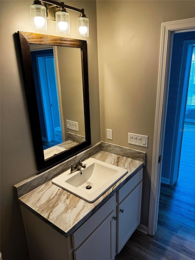 227 Bay St, Port St Joe, FL 32456 - bathroom with vanity, wood finished floors, and baseboards