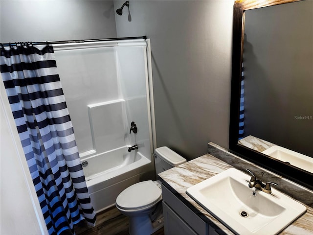 227 Bay St, Port St Joe, FL 32456 - bathroom featuring toilet, shower / tub combo with curtain, vanity, and wood finished floors