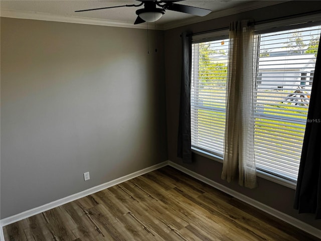227 Bay St, Port St Joe, FL 32456 - unfurnished room with a ceiling fan, crown molding, dark wood finished floors, and baseboards