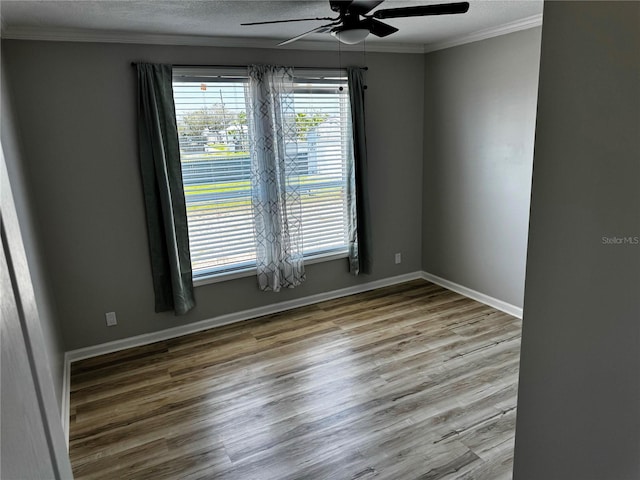 227 Bay St, Port St Joe, FL 32456 - unfurnished room with ceiling fan, crown molding, wood finished floors, baseboards, and a textured ceiling