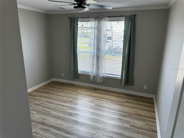 227 Bay St, Port St Joe, FL 32456 - unfurnished room with a ceiling fan, ornamental molding, wood finished floors, and baseboards
