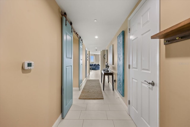241 Riverside Dr Unit 902, Holly Hill, FL 32117 - corridor featuring light tile patterned flooring, a barn door, and recessed lighting