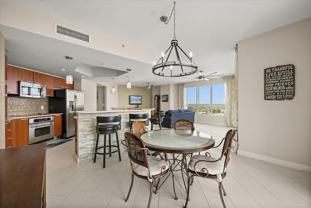 241 Riverside Dr Unit 902, Holly Hill, FL 32117 - dining room with ceiling fan, a chandelier, and light tile patterned flooring