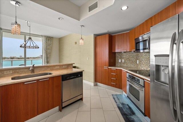241 Riverside Dr Unit 902, Holly Hill, FL 32117 - kitchen featuring appliances with stainless steel finishes, brown cabinets, modern cabinets, and recessed lighting