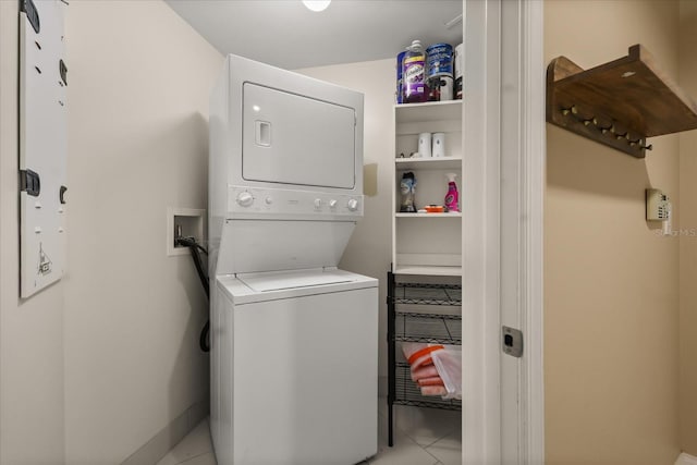 241 Riverside Dr Unit 902, Holly Hill, FL 32117 - laundry room featuring stacked washer / drying machine and light tile patterned flooring