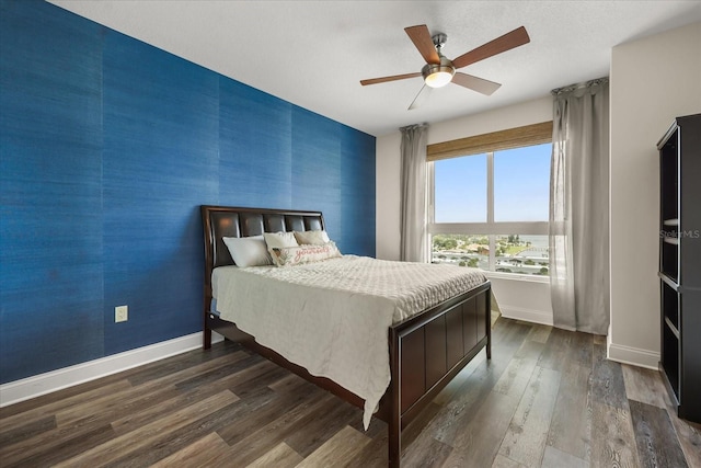 241 Riverside Dr Unit 902, Holly Hill, FL 32117 - bedroom with an accent wall, dark wood-style flooring, and ceiling fan