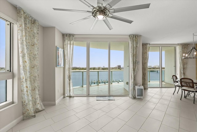 241 Riverside Dr Unit 902, Holly Hill, FL 32117 - unfurnished room featuring a chandelier, a water view, ceiling fan, and light tile patterned flooring